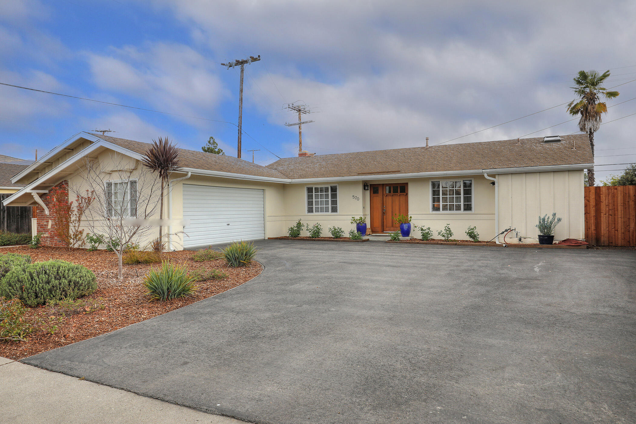 570 Amherst Drive Goleta, CA 93117 - Photo 2 of 31 a view of a house with a backyard and a garage