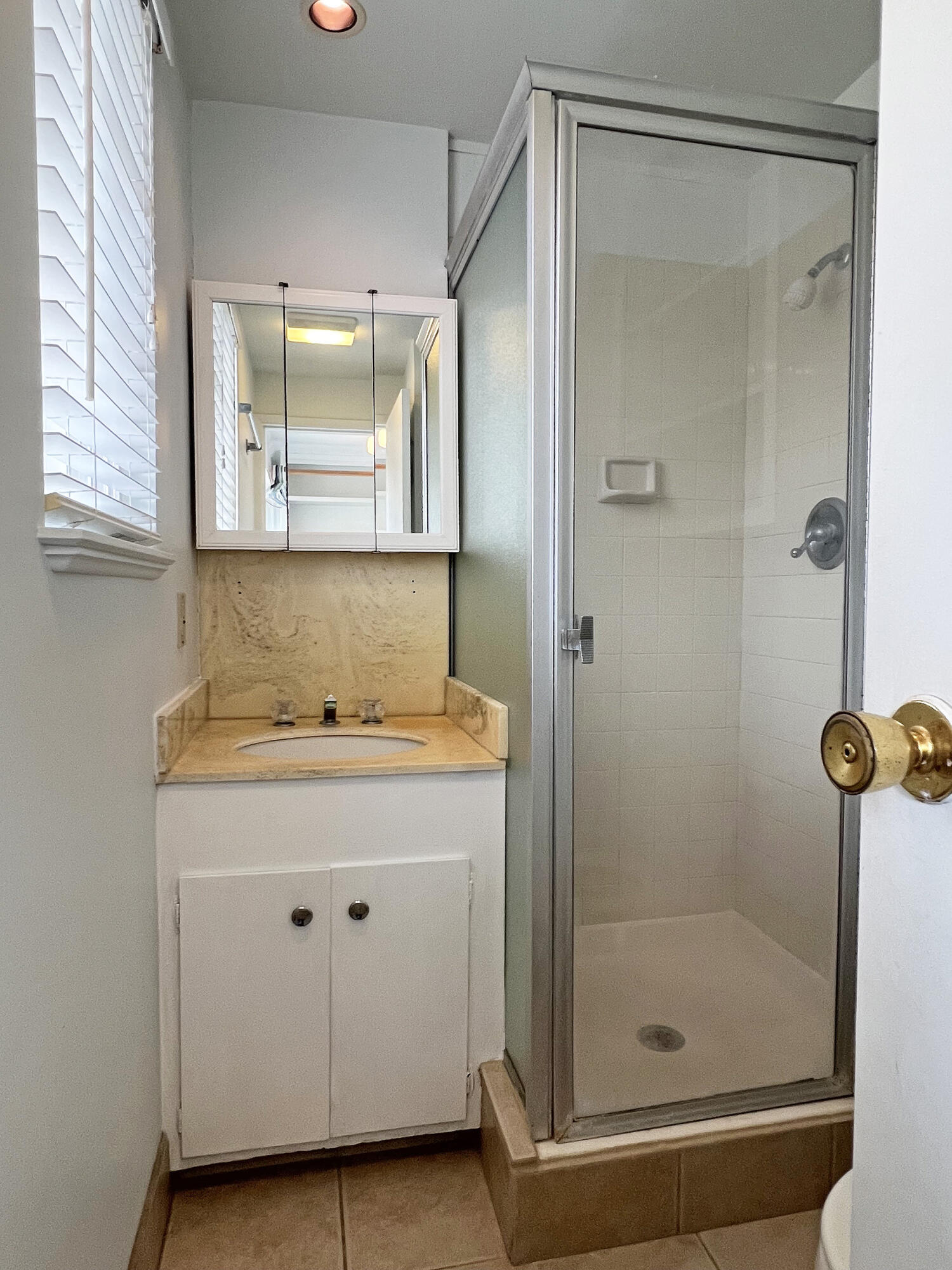570 Amherst Drive Goleta, CA 93117 - Photo 24 of 31 a bathroom with a granite countertop sink mirror and shower