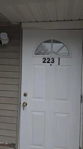 a view of kitchen cabinetry and a refrigerator