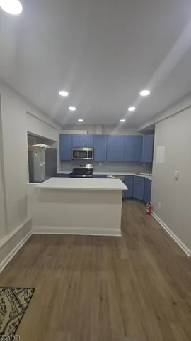 a view of kitchen and refrigerator