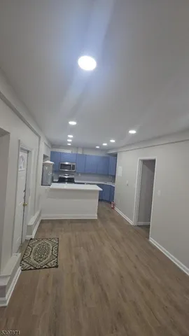 a view of kitchen with stainless steel appliances a refrigerator and a stove top oven