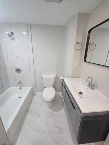 a bathroom with a sink a toilet and bathtub