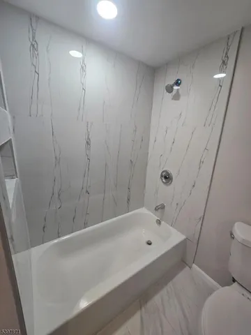 a bathroom with a bathtub and toilet