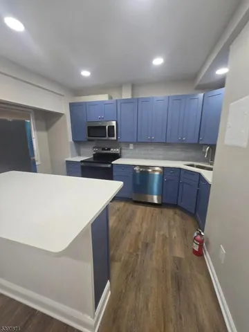 a kitchen with stainless steel appliances a refrigerator and a stove top oven