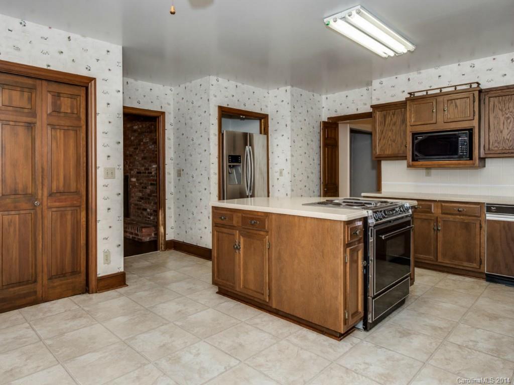 409 Whitestone Road Charlotte, NC 28270 - Photo 12 of 18 a kitchen with stainless steel appliances granite countertop a stove and a sink