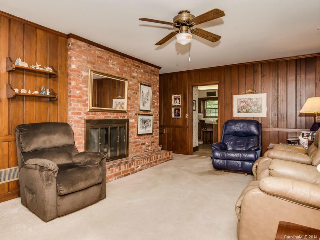 409 Whitestone Road Charlotte, NC 28270 - Photo 14 of 18 a living room with furniture a fireplace and a flat screen tv