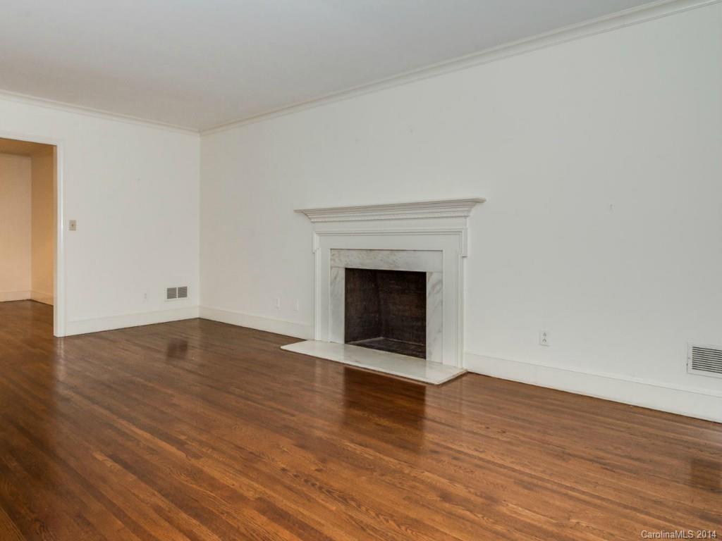 409 Whitestone Road Charlotte, NC 28270 - Photo 3 of 18 a view of empty room with wooden floor and fireplace