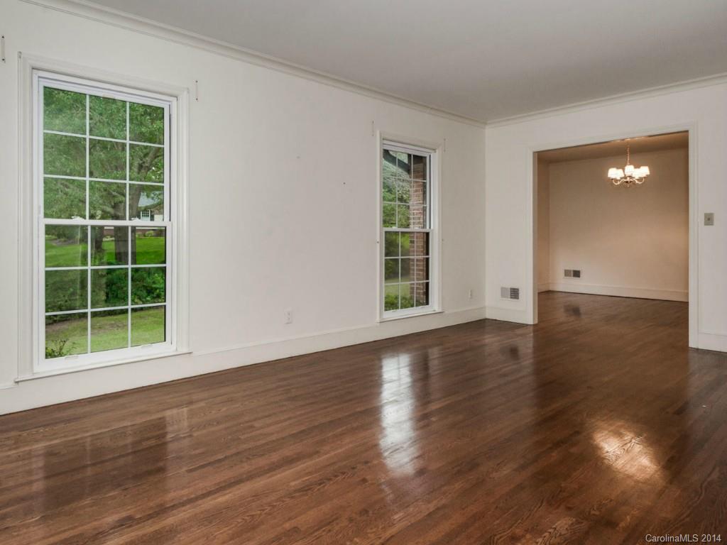 409 Whitestone Road Charlotte, NC 28270 - Photo 5 of 18 an empty room with wooden floor and windows