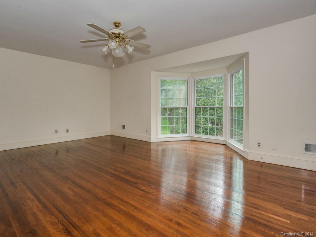 409 Whitestone Road Charlotte, NC 28270 - Photo 6 of 18 wooden floor in an empty room with a window
