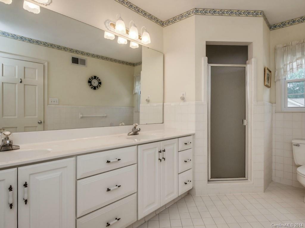409 Whitestone Road Charlotte, NC 28270 - Photo 7 of 18 a bathroom with a double vanity sink and mirror with shower