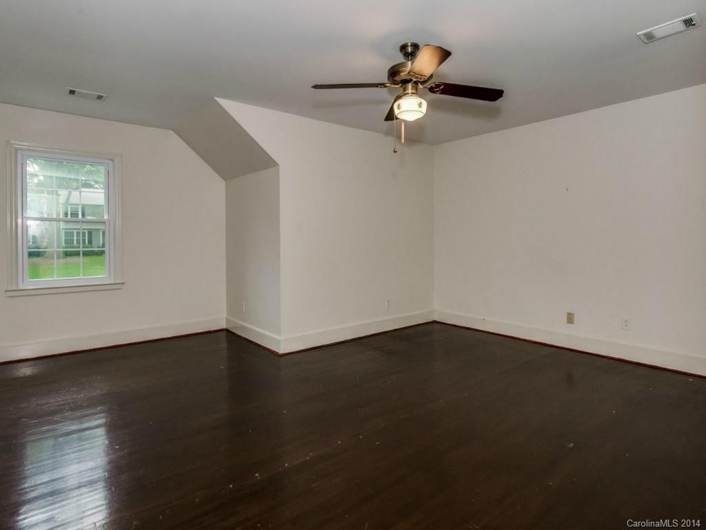 409 Whitestone Road Charlotte, NC 28270 - Photo 8 of 18 an empty room with wooden floor and windows