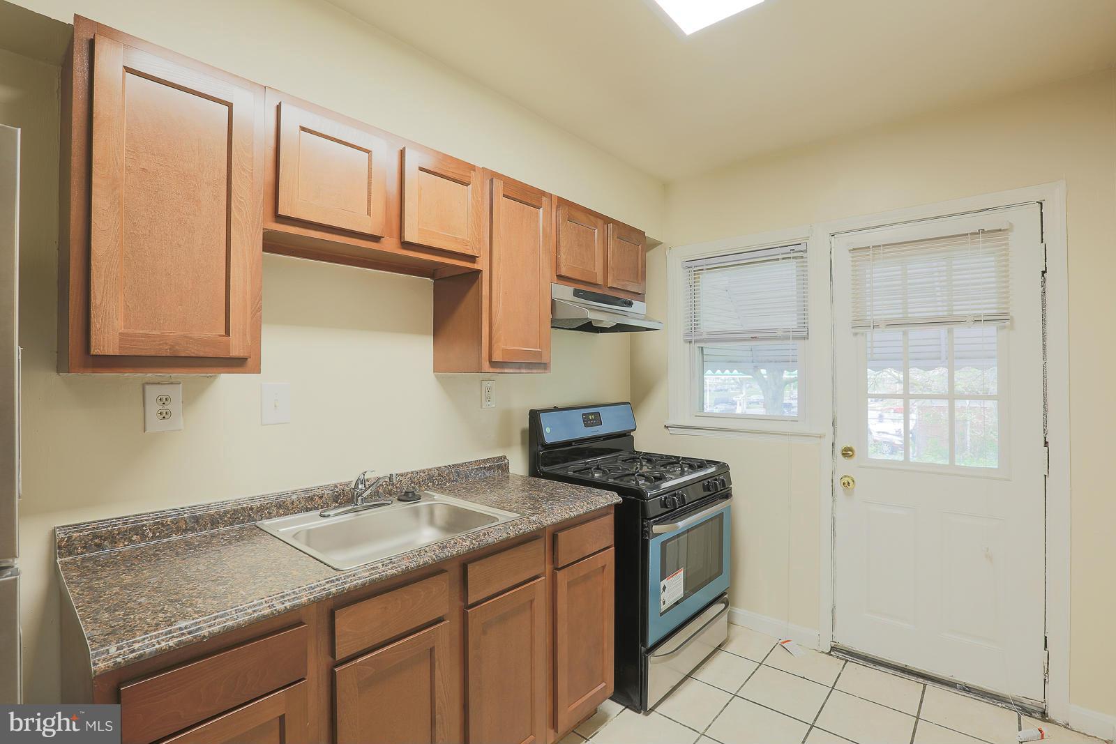 4522 Marble Hall Road Baltimore, MD 21239 - Photo 14 of 28 a kitchen with granite countertop a sink stove and cabinets