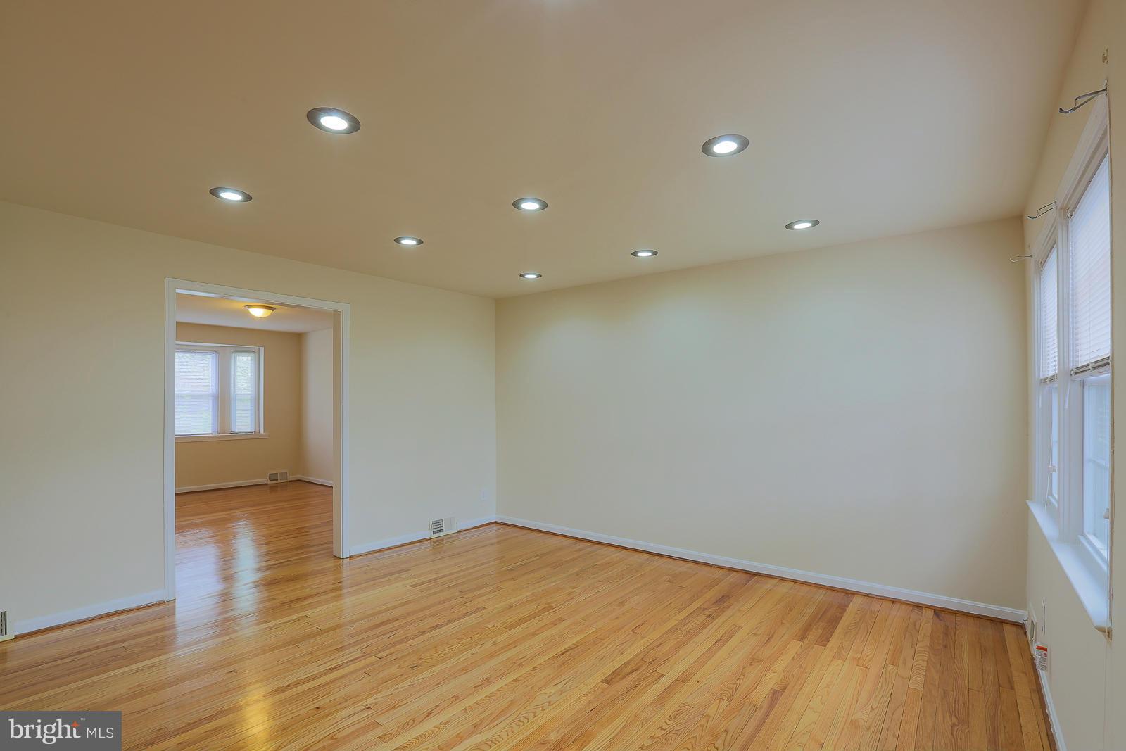 4522 Marble Hall Road Baltimore, MD 21239 - Photo 5 of 28 a view of empty room with wooden floor and fan