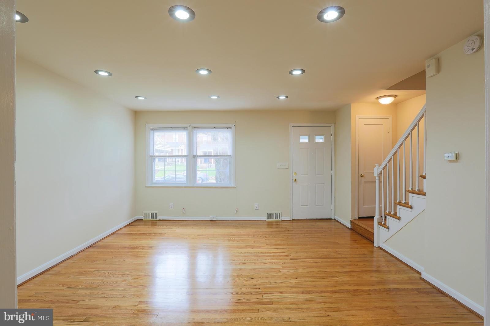4522 Marble Hall Road Baltimore, MD 21239 - Photo 9 of 28 a view of empty room with wooden floor and fan