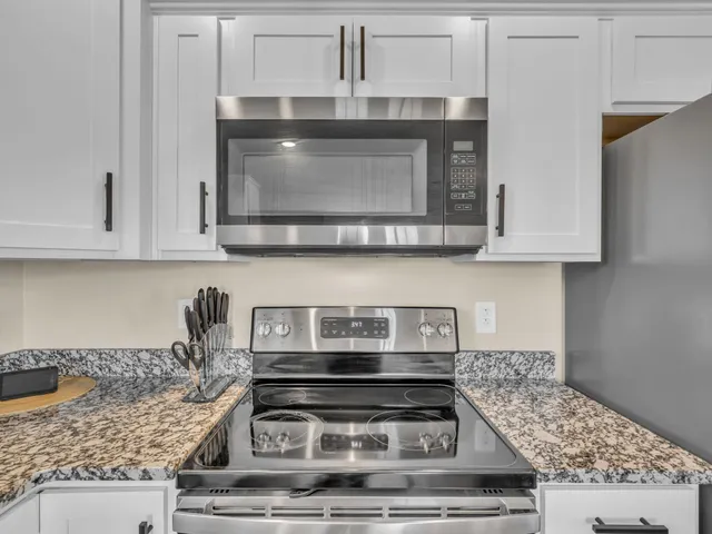 a stove top oven sitting inside of a kitchen