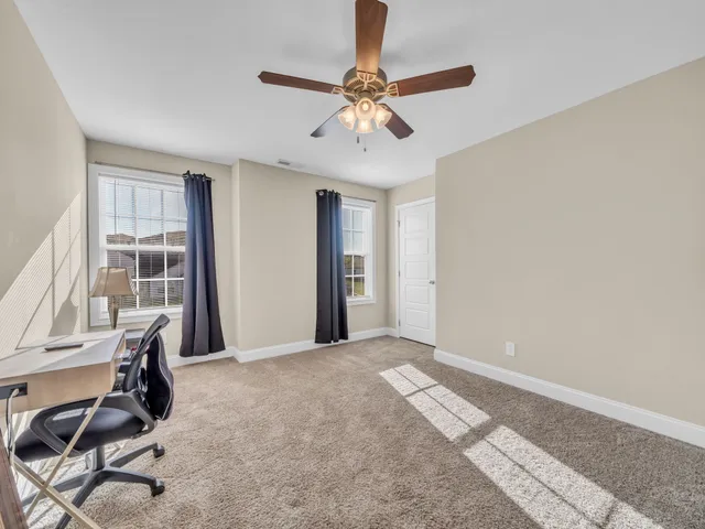 a view of a livingroom with a window and furniture