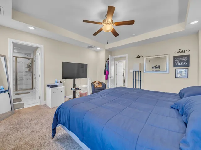 a bed room with a bed and a flat screen tv