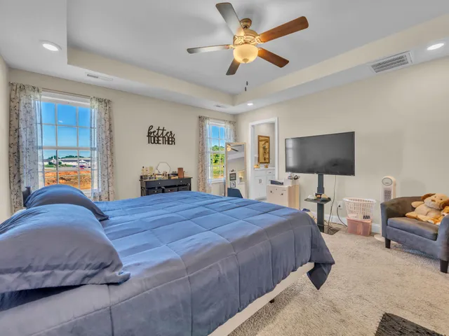 a bedroom with a bed gym equipment and a chandelier