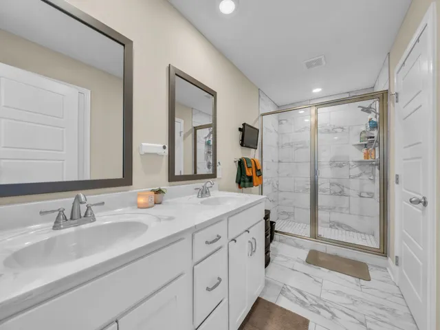 a bathroom with double vanity sink and a mirror