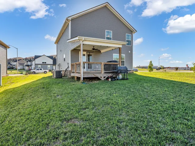 a view of a house with a big yard and sitting area