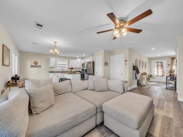 a living room with furniture and kitchen view