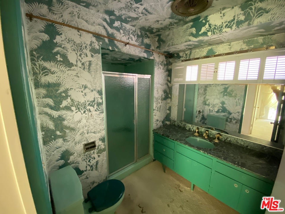 9748 Oak Pass Road Beverly Hills, CA 90210 - Photo 11 of 20 a bathroom with a sink a toilet and shower