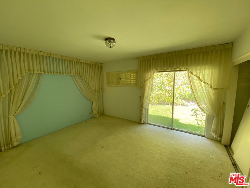 9748 Oak Pass Road Beverly Hills, CA 90210 - Photo 12 of 20 a view of an empty room with a window
