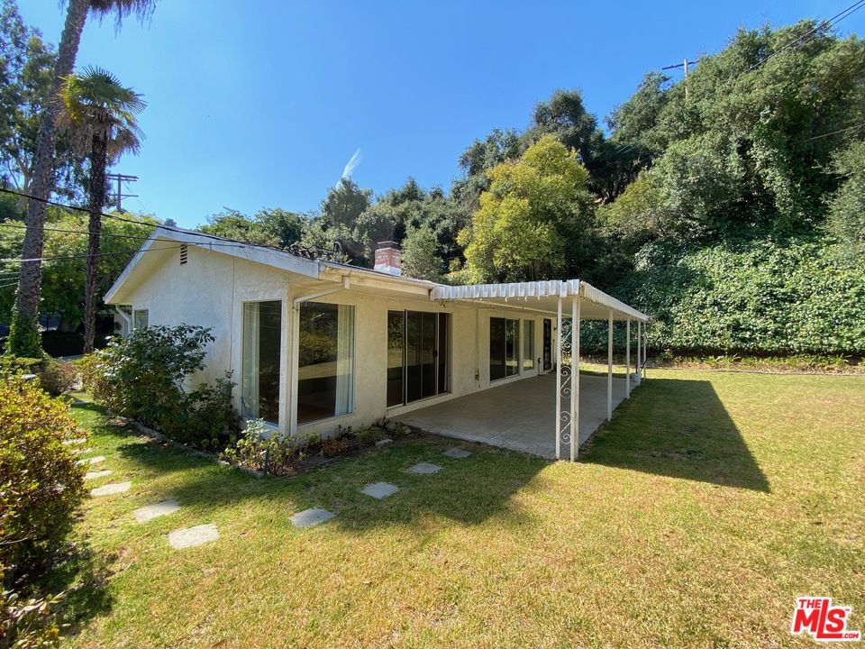 9748 Oak Pass Road Beverly Hills, CA 90210 - Photo 15 of 20 a view of a house with pool and a yard