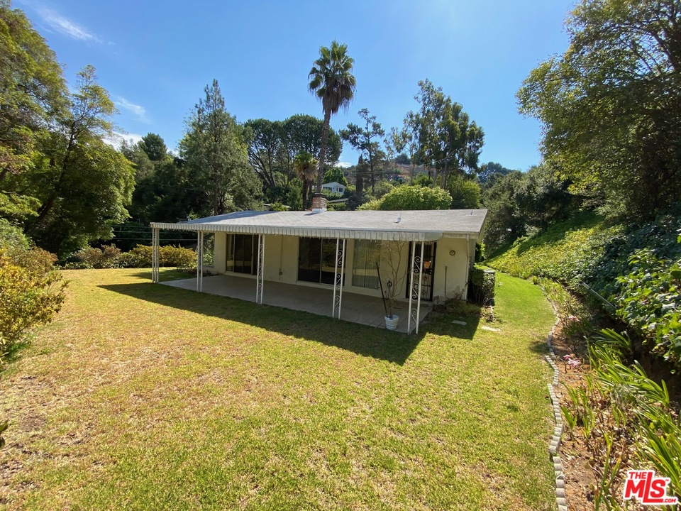 9748 Oak Pass Road Beverly Hills, CA 90210 - Photo 16 of 20 a view of house with swimming pool and yard