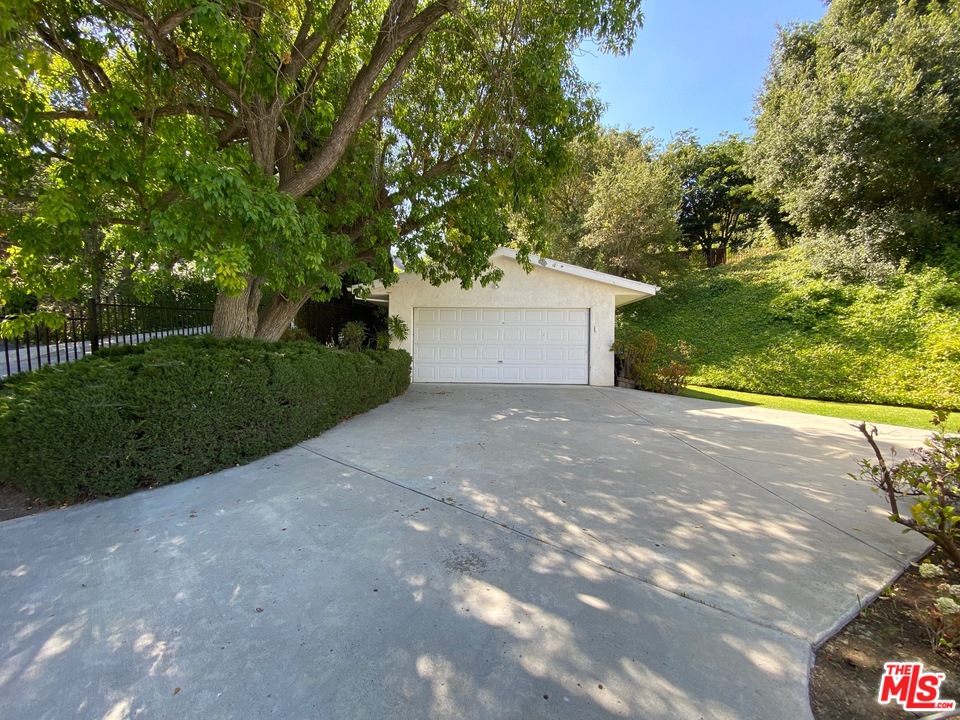 9748 Oak Pass Road Beverly Hills, CA 90210 - Photo 19 of 20 a view of a yard with plants and trees