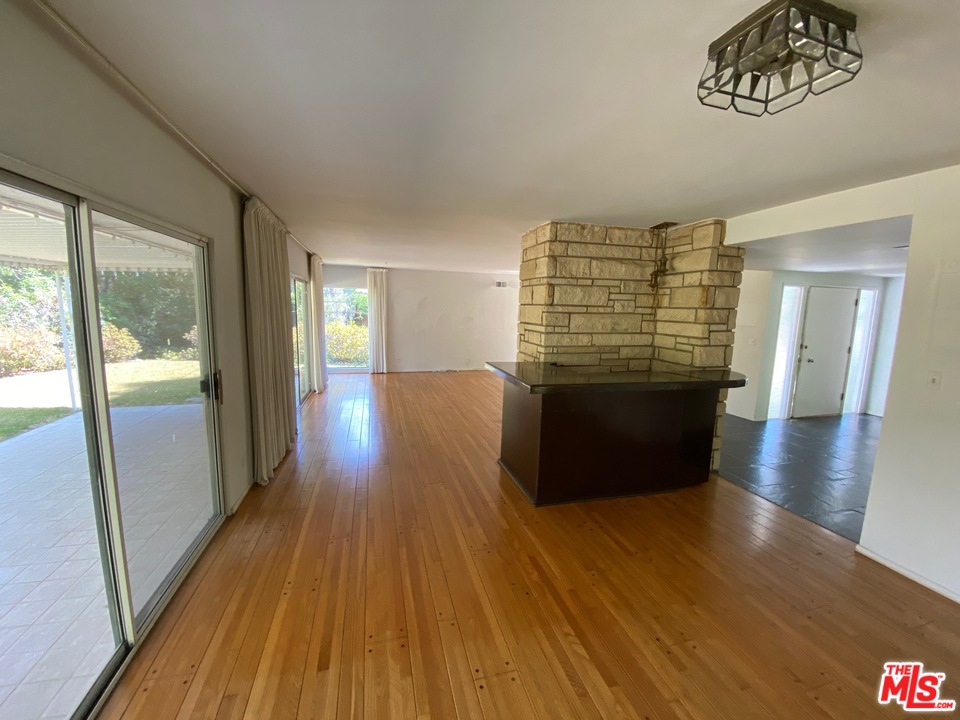 9748 Oak Pass Road Beverly Hills, CA 90210 - Photo 7 of 20 a view of wooden floor and windows in a room