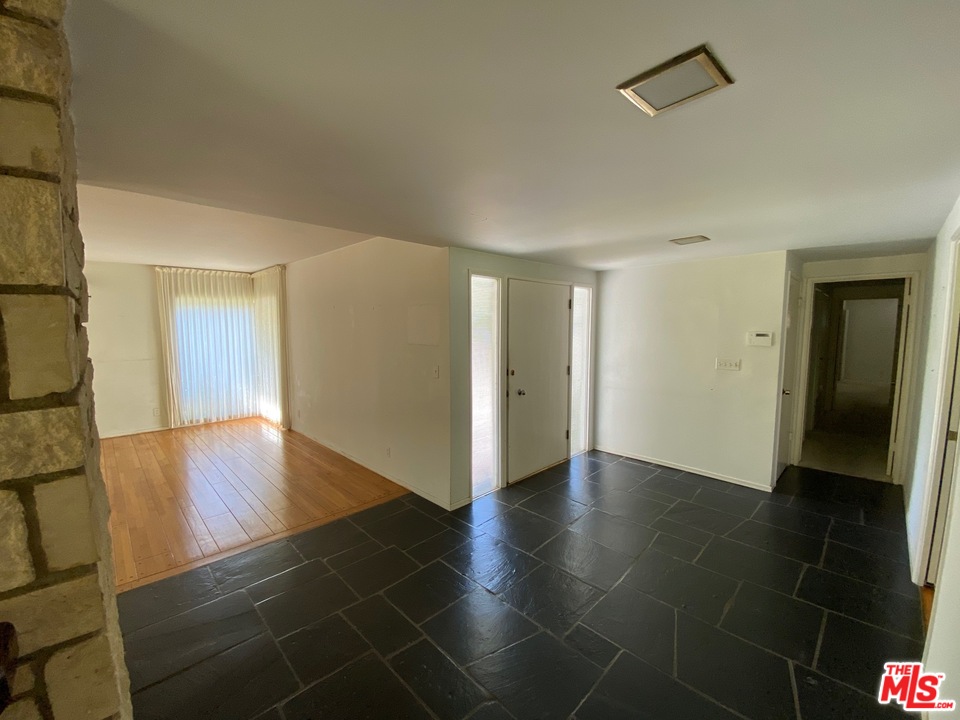 9748 Oak Pass Road Beverly Hills, CA 90210 - Photo 9 of 20 a view of empty room with wooden floor and fan