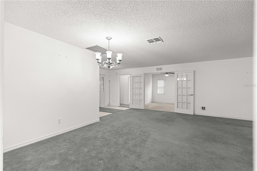 9614 Southwest 93rd Loop Ocala, FL 34481 - Photo 12 of 45 en view of an empty room with chandelier