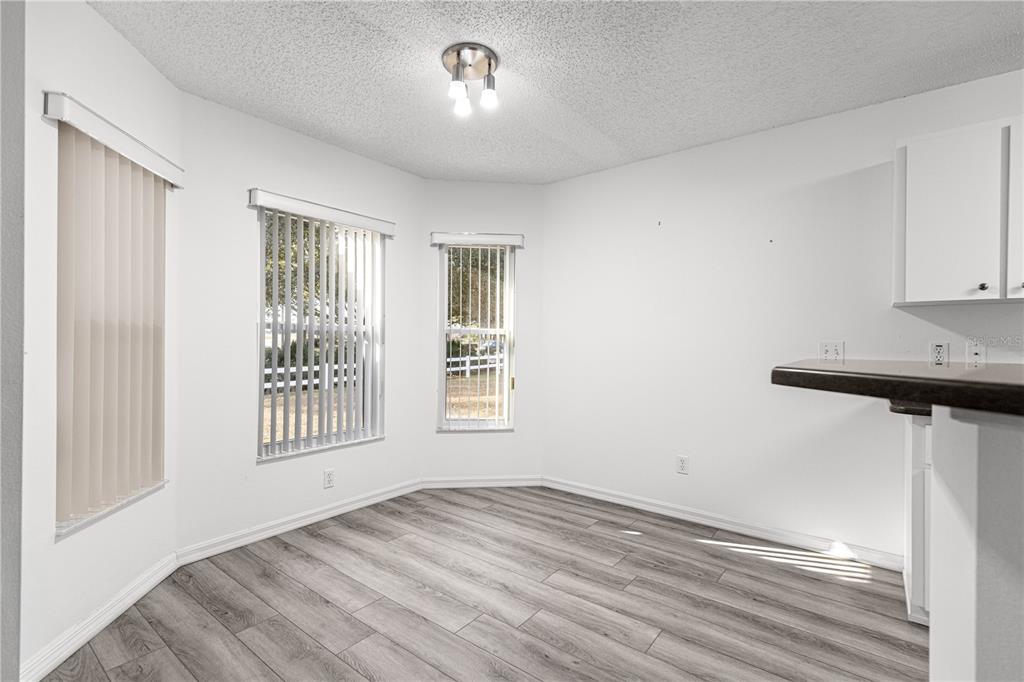 9614 Southwest 93rd Loop Ocala, FL 34481 - Photo 19 of 45 a view of empty room with wooden floor and fan