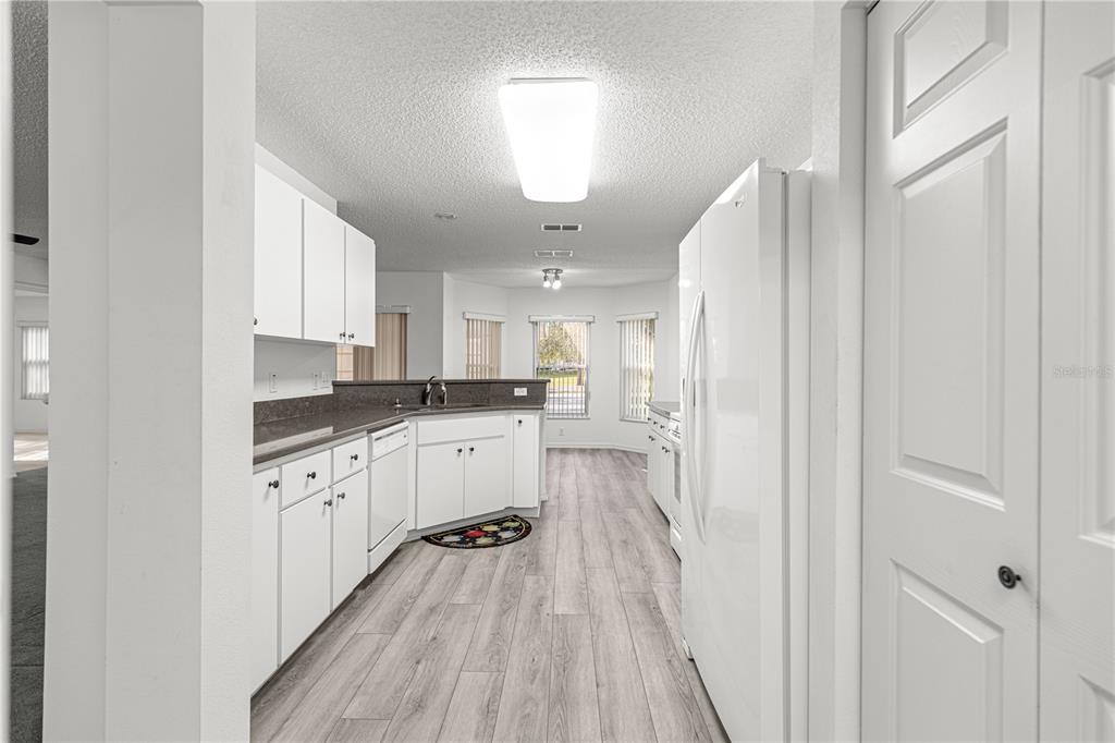 9614 Southwest 93rd Loop Ocala, FL 34481 - Photo 24 of 45 a kitchen with cabinets and wooden floor