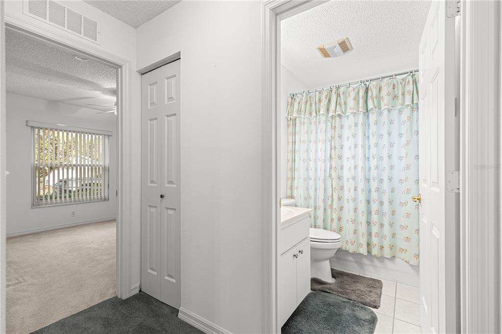 9614 Southwest 93rd Loop Ocala, FL 34481 - Photo 34 of 45 a bathroom with a shower curtain and a toilet