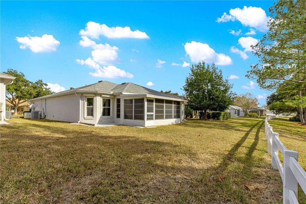 9614 Southwest 93rd Loop Ocala, FL 34481 - Photo 39 of 45 a front view of a house with a yard