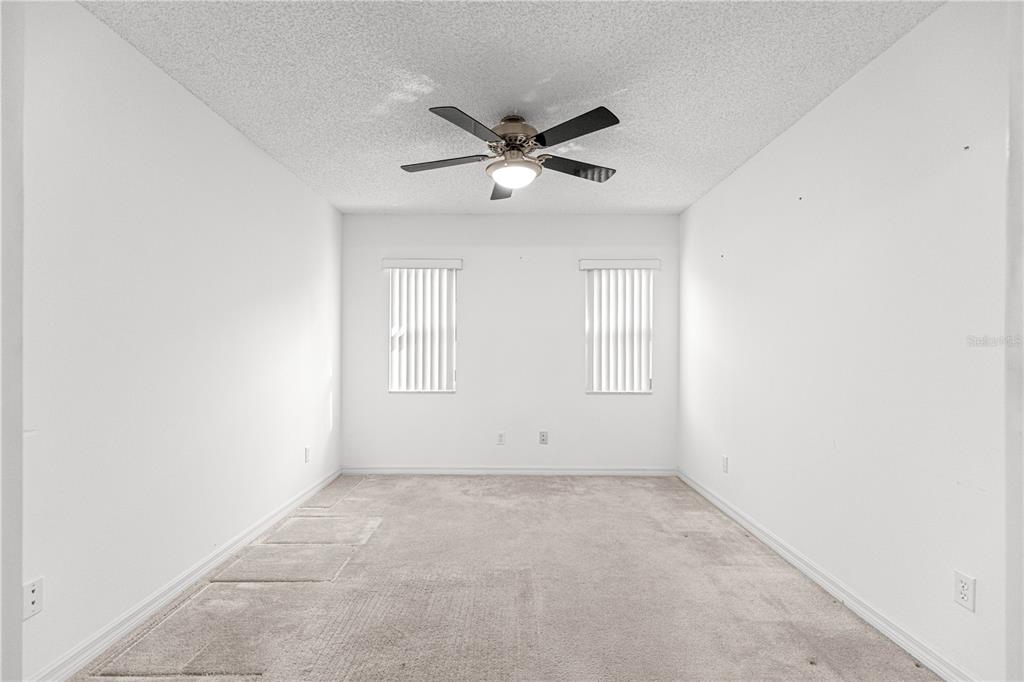 9614 Southwest 93rd Loop Ocala, FL 34481 - Photo 5 of 45 an empty room with a ceiling fan and window