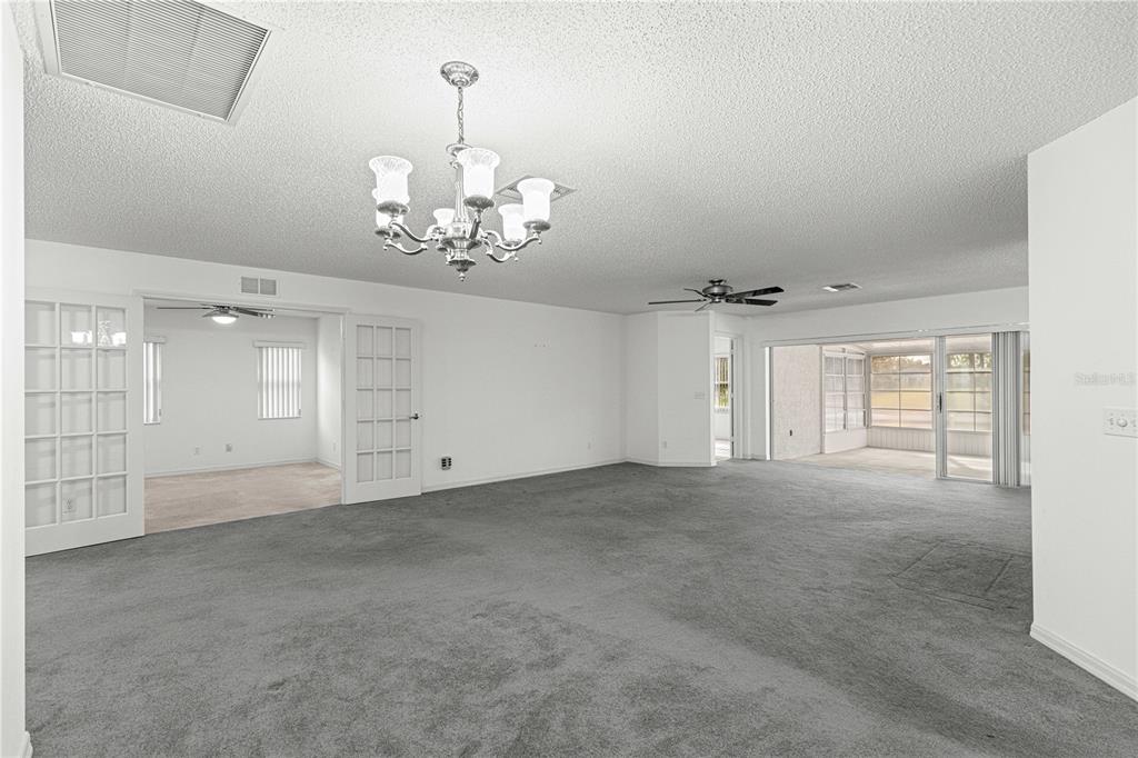 9614 Southwest 93rd Loop Ocala, FL 34481 - Photo 8 of 45 en empty room with windows and ceiling fan