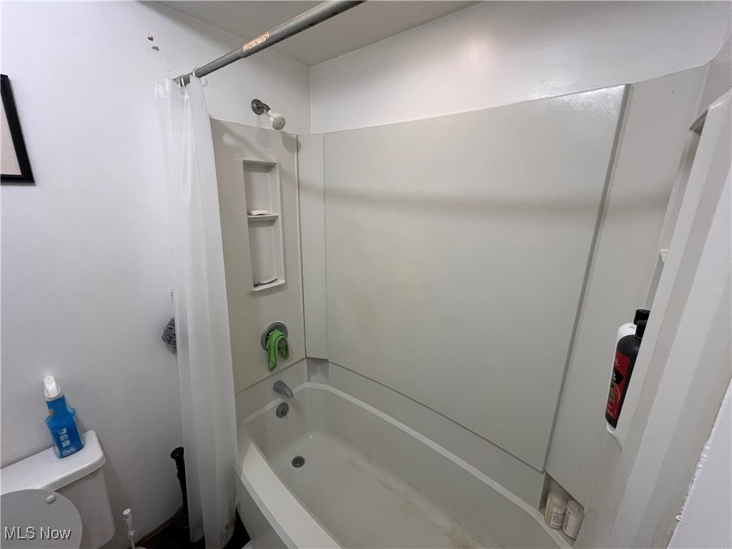 1455 Welch Road Painesville, OH 44077 - Photo 27 of 42 Bathroom with shower / bathtub combination with curtain and toilet