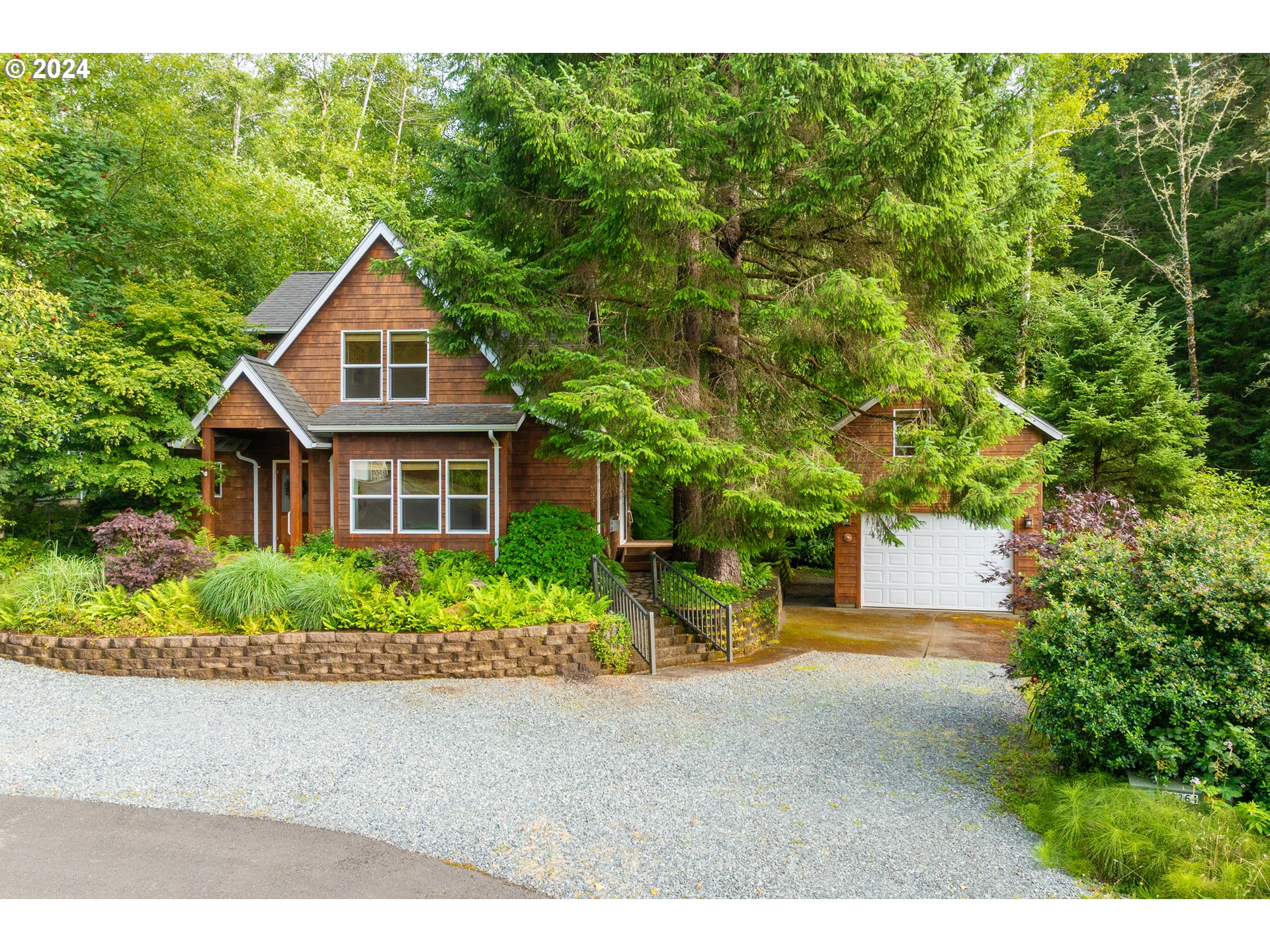 9355 Dewolf Road Nehalem, OR 97131 - Photo 2 of 33 a front view of a house with a yard