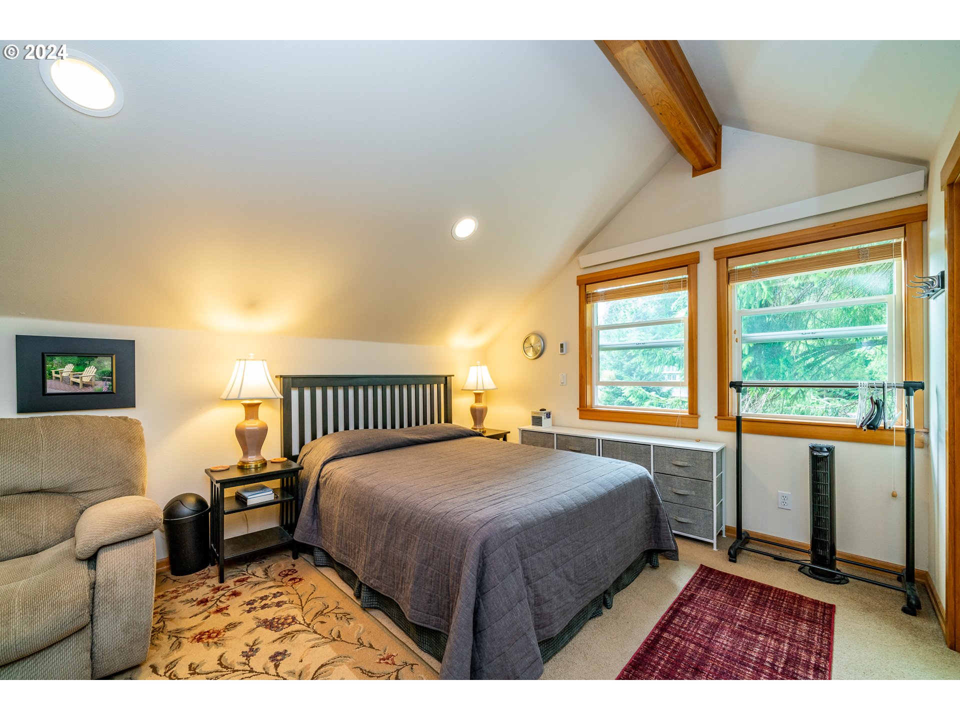 9355 Dewolf Road Nehalem, OR 97131 - Photo 26 of 33 a bedroom with a bed and a large window