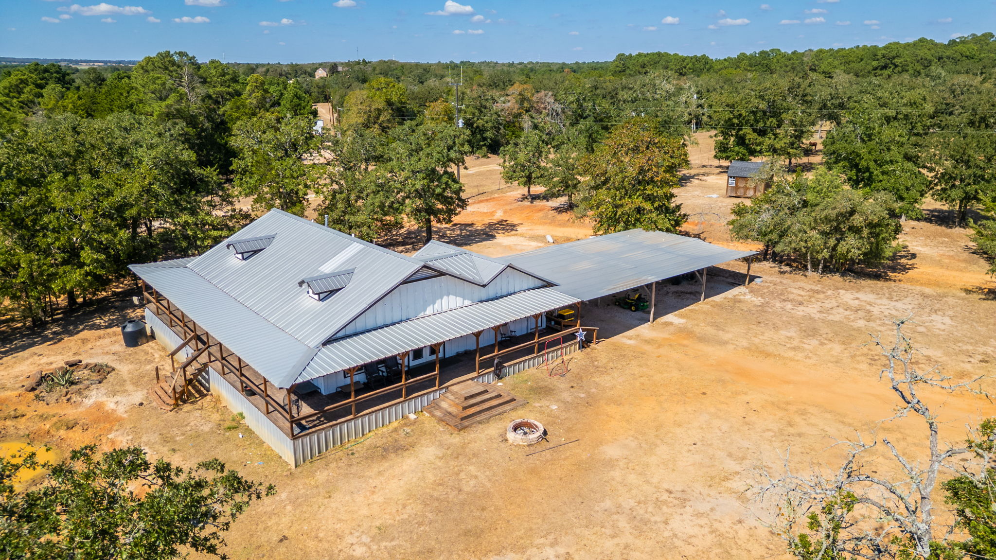 274 Old Potato Road Paige, TX 78659 - Photo 1 of 39 Perched on a vast, private expanse, this charming dwelling offers a deep covered porch and a dedicated outdoor fire pit.