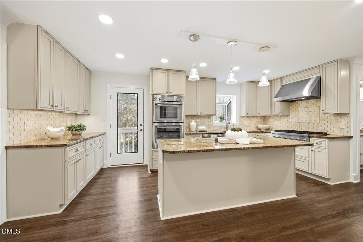 1603 Green Pine Court Raleigh, NC 27614 - Photo 13 of 70 a large kitchen with stainless steel appliances granite countertop a lot of counter space and wooden floors