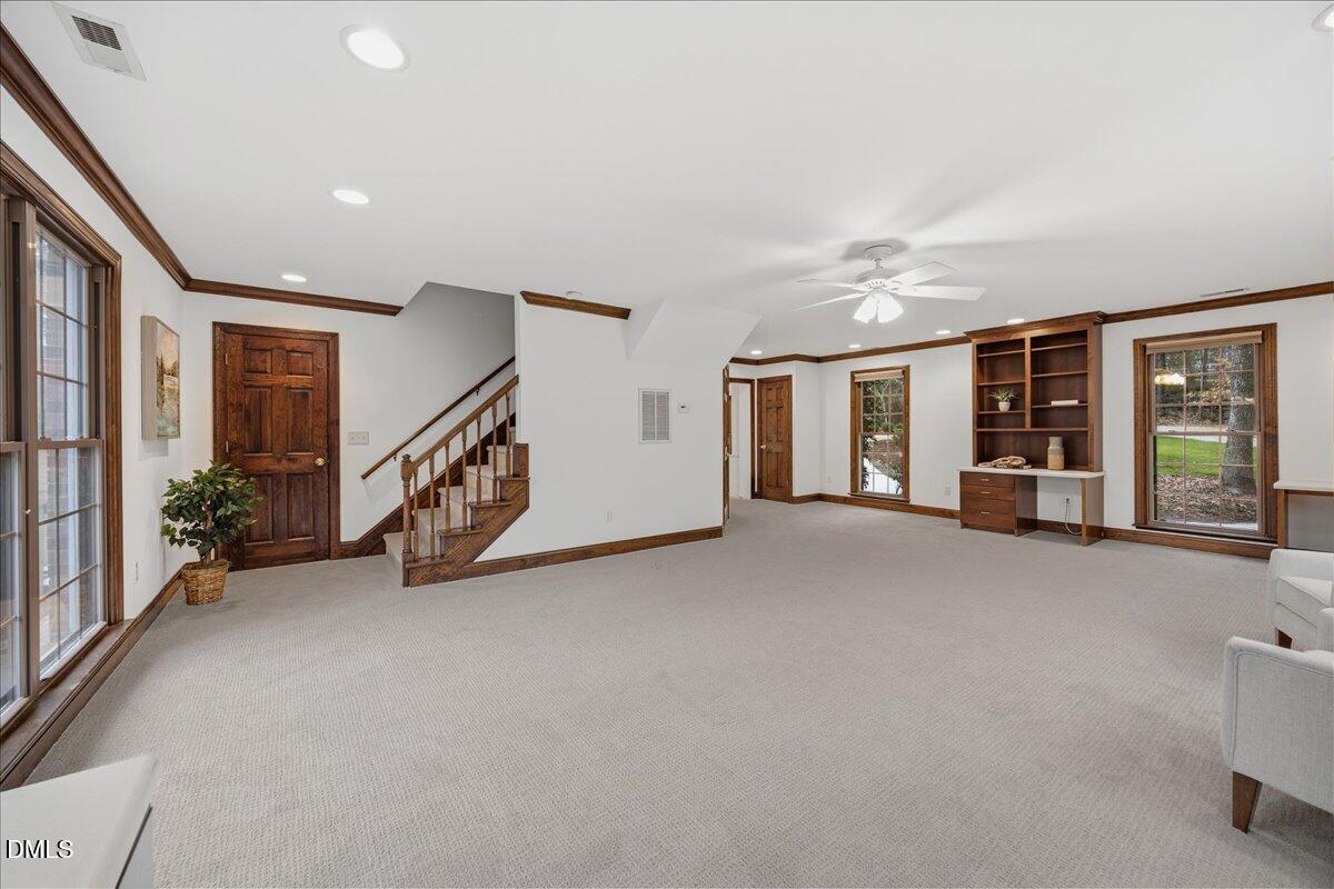 1603 Green Pine Court Raleigh, NC 27614 - Photo 28 of 70 an empty room with staircase ceiling fan and windows
