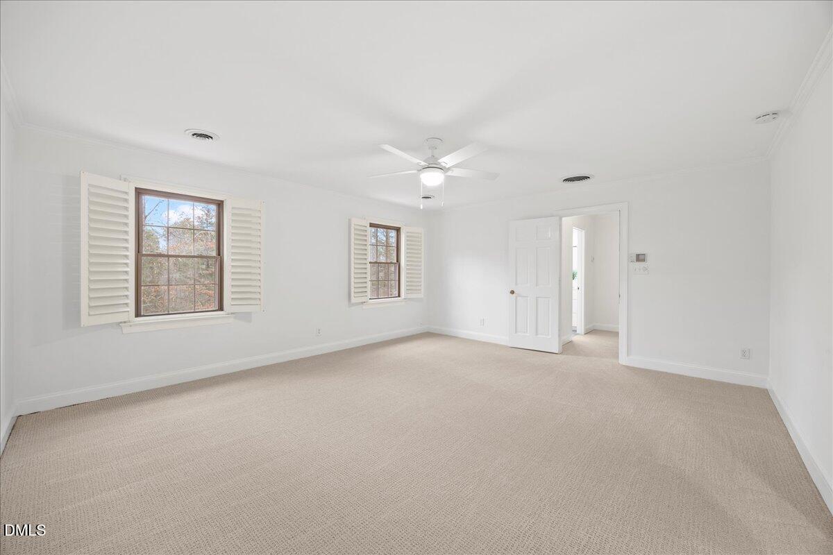 1603 Green Pine Court Raleigh, NC 27614 - Photo 39 of 70 an empty room with windows and chandelier fan
