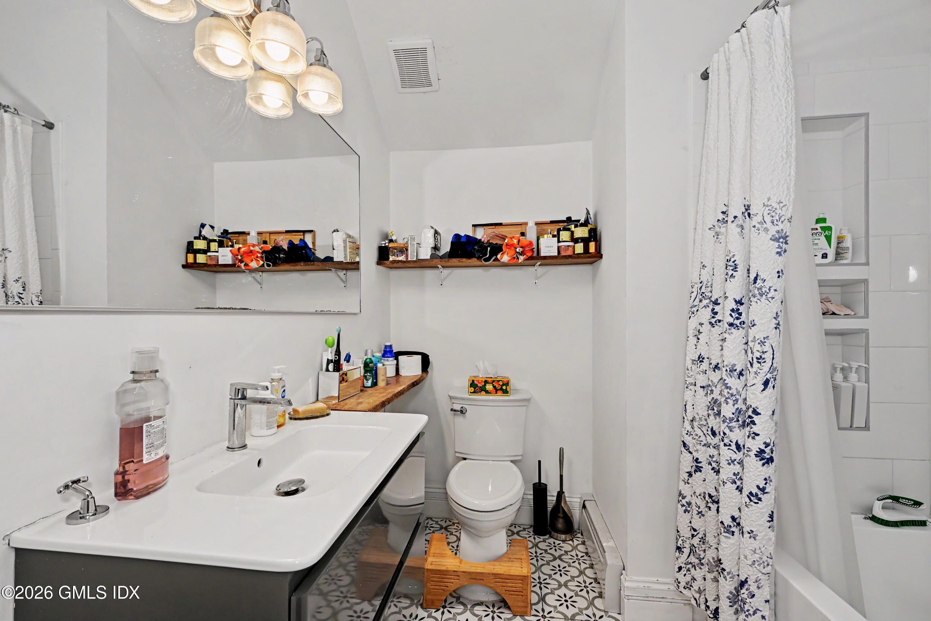 37 Prospect Street Greenwich, CT 06830 - Photo 25 of 41 a bathroom with a sink a toilet and shower curtain