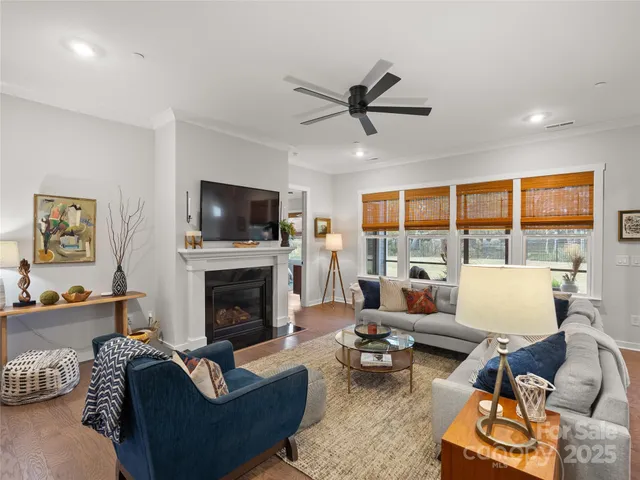 a living room with furniture fireplace and a large window