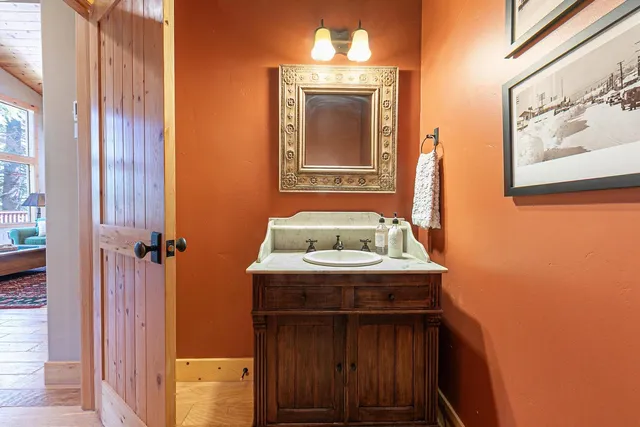 a bathroom with a sink a mirror and a window