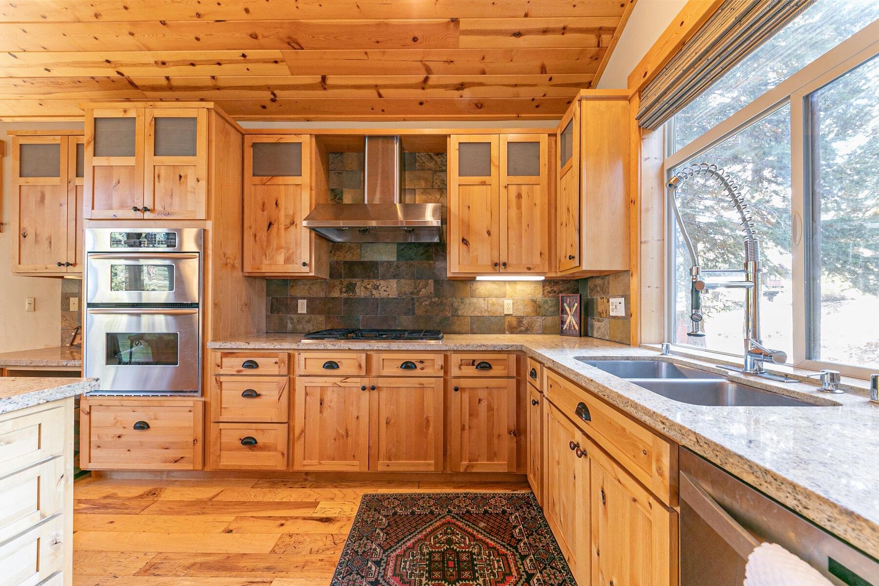 11707 Ski Slope Way Truckee, CA 96161 - Photo 12 of 28 a kitchen with stainless steel appliances granite countertop a sink and cabinets